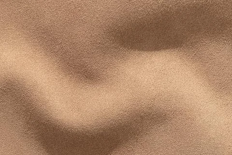 Suede leather texture background with smooth waves and warm tones creating a Stock Photos