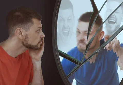 Suffering from hallucinations. Man looking in broken mirror and seeing hims.. Fotos de archivo