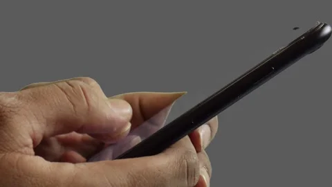 Suffering from thumb finger pain while using smartphone on grey background. Stock Footage 153312125