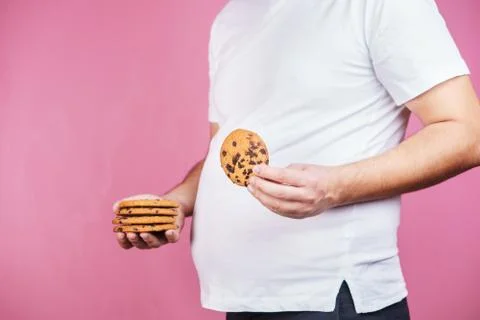 Sugar addiction, obese man with stack of cookies Stock Photos
