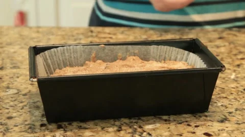 Sugar being sprinkled onto cake mix in cake tin Stock Footage 10915726