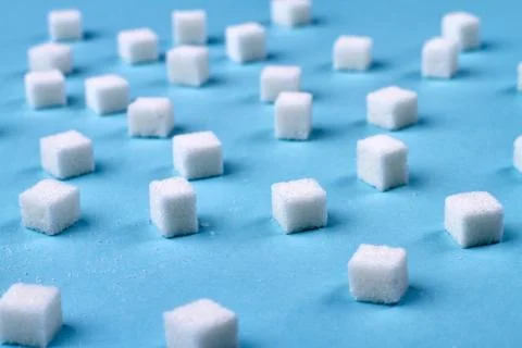 Sugar on the blue background. Stock Photos