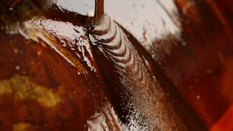 Sugar cane molasses pouring on industrial equipment in a rum distillery Stock Footage