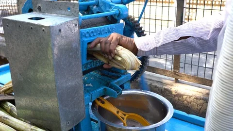 Sugar cane press extracting fresh cane juice on street market. Rishikesh, India Stock Footage 100416375