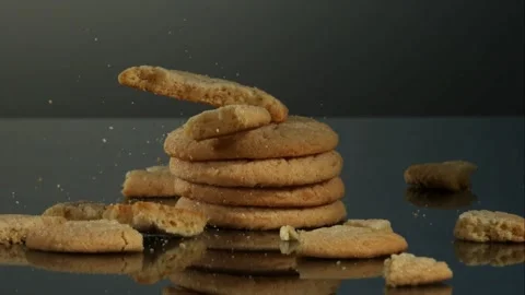 Sugar cookie falling on stack and breaking into crumbs Stock Footage 327514020