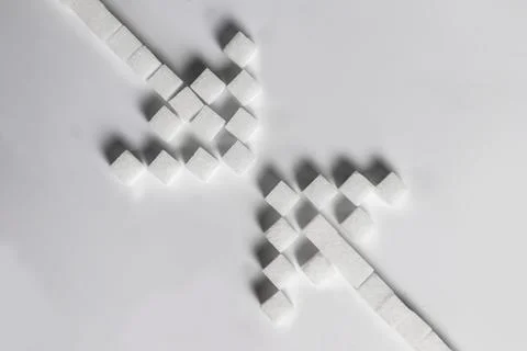Sugar cube arrows meet each other, choices and journeys. Stock Photos