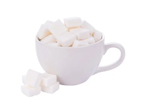 Sugar cube in cup on white background Photos