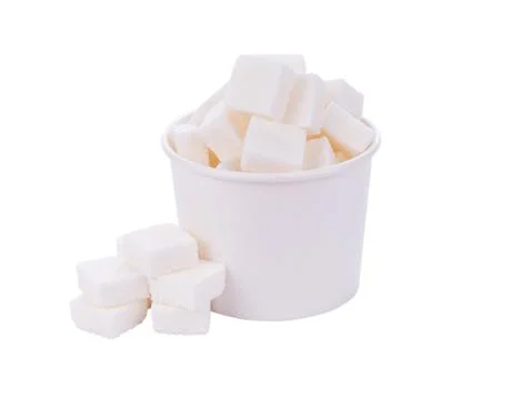 Sugar cube in cup on white background Stock Photos