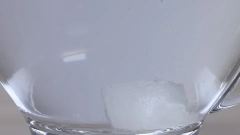 Sugar Cube Dissolving in a Glass Mug of Hot Water Stock Footage 342231278