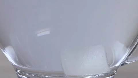 Sugar Cube Dissolving in a Glass Mug of Hot Water Stock Footage 343837106