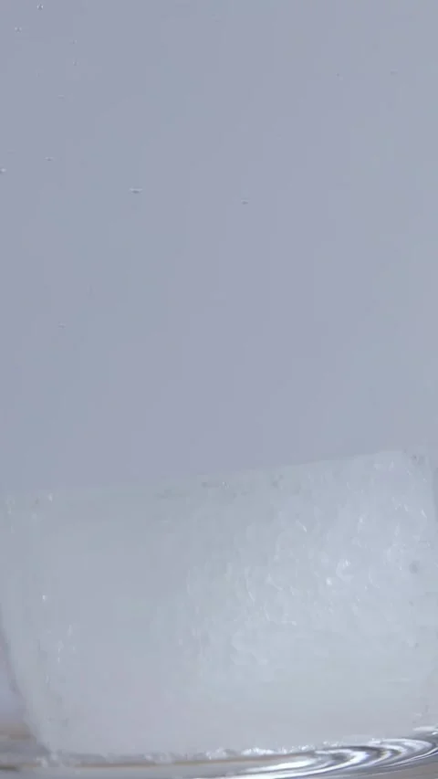 Sugar Cube Dissolving in Hot Water Inside Glass Mug Stock Footage 342494731