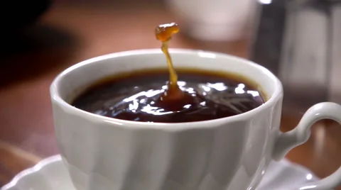 Sugar cube dropped into black coffee, super slow motion Stock Footage 55245677