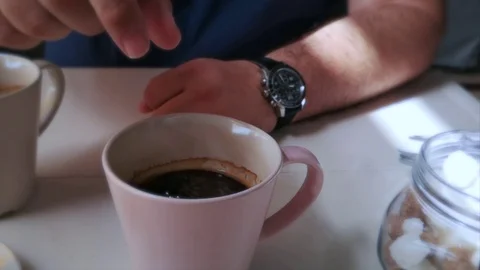 Sugar cube dropped in cap of coffee. Slow motion Stock Footage 97593375