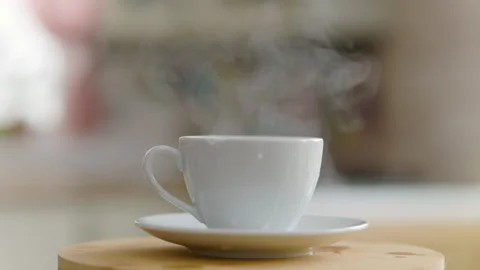 A Sugar Cube Falls Into A Coffee Cup And Splashes Scatter And Steam Goes Stock Footage 152774883