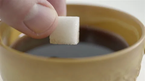 Sugar cube soaked in coffee. 4K UHD Stock Footage 48923997