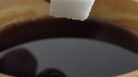Sugar cube soaked in coffee. Slow Motion Stock Footage 48872055