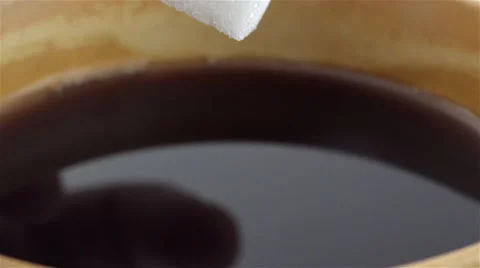 Sugar cube soaked in coffee. Slow Motion Stock Footage 48929044