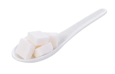 Sugar cube in spoon on white background 写真素材