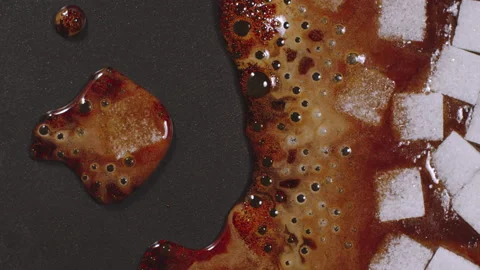 Sugar cube boiling on a black pan. Close Up, Top view Stock Footage 131588097