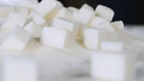 Sugar cubes are on a table on granulated sugar Stock Footage 178457440