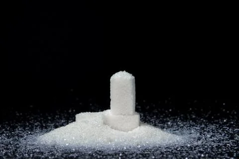 Sugar cubes on a black background. Stock Photos