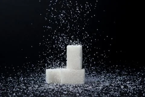 Sugar cubes on a black background.  Stock Photos