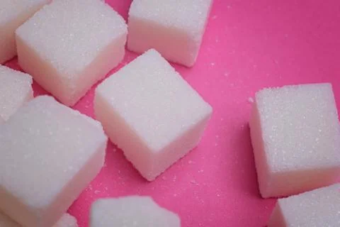 Sugar cubes on a bright pink background. Stock-Fotos
