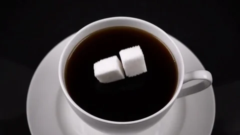 Sugar cubes dropped into coffee creating splash 스톡 동영상 71102867