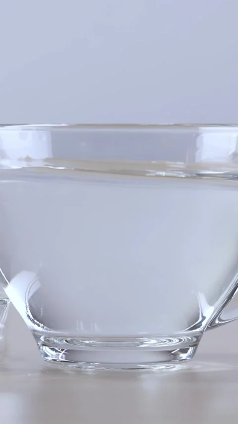 Sugar Cubes Dropping into Glass Cup of Water Vídeos de archivo 342693895