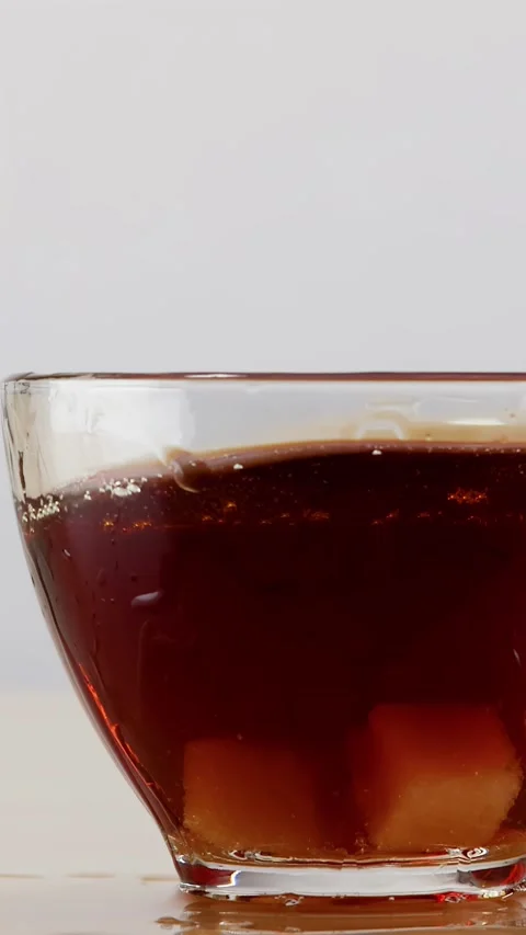 Sugar Cubes Dropping into Glass Cup of Coffee with Liquid Splash Stock Footage 346271338