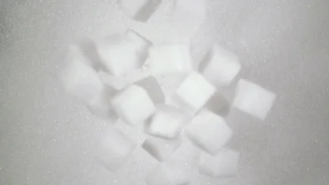 Sugar cubes fall down on sugar. Slow mo, top view Video stock 74377960
