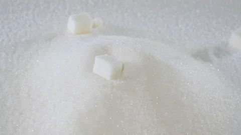 Sugar cubes fall on granulated sugar close-up Stock Footage 178450786