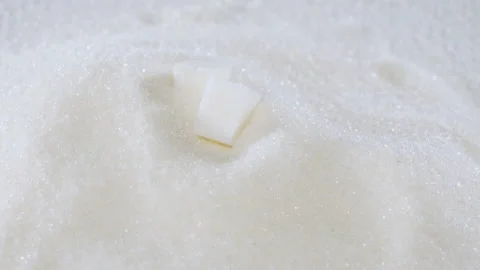 Sugar cubes fall on granulated sugar close-up Stock Footage 178451650