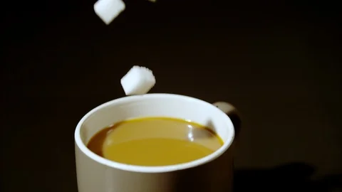 Sugar cubes falling into coffee cup, Ultra Slow Motion Stock Footage 86578018