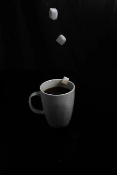 Sugar Cubes Falling into Coffee Stock Photos
