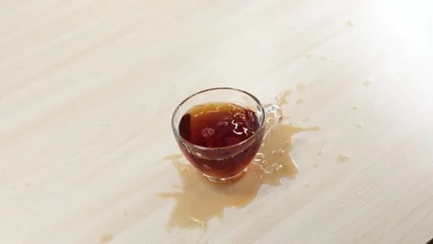 Sugar Cubes Falling Into Glass Cup of Black Tea Causing Splash Stock Footage 345792762
