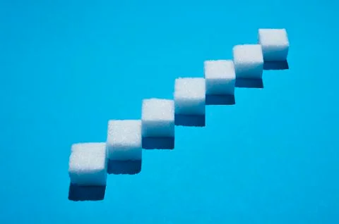 Sugar cubes forming pattern on blue background 写真素材