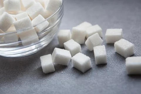 Sugar cubes on gray background Stock Photos