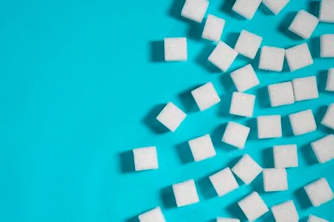 Sugar cubes on an on light blue background Stock Photos