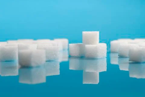 Sugar cubes on an on light blue background Stock Photos