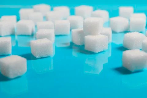 Sugar cubes on an on light blue background Stock Photos