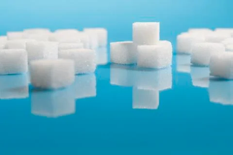 Sugar cubes on an on light blue background Stock Photos