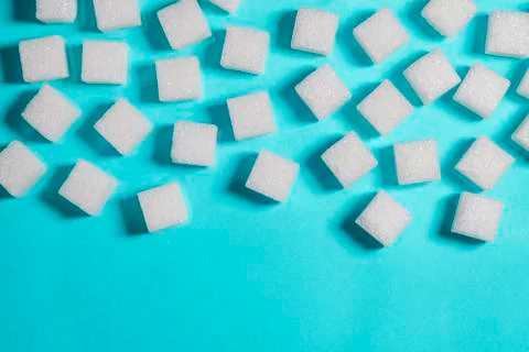 Sugar cubes on an on light blue background Stock Photos