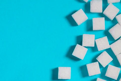 Sugar cubes on an on light blue background Stock Photos