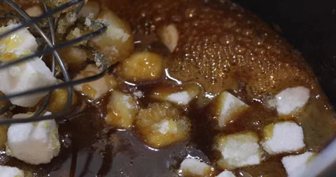 Sugar cubes melting and caramelizing in hot pan Stock Footage 329030373