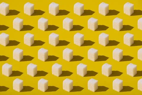 Sugar cubes pattern on yellow background. Abstract, minimal style. Stock Photos