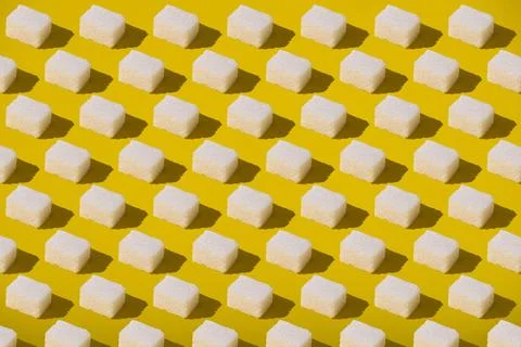 Sugar cubes pattern on yellow background. Abstract, minimal style. Foto stock