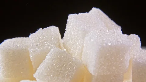 Sugar Cubes rotating on black background macro Stock Footage 122257070