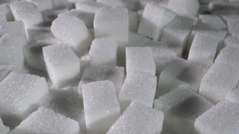 Sugar cubes scattered on a white surface create an interesting texture and Stock Footage 322145770