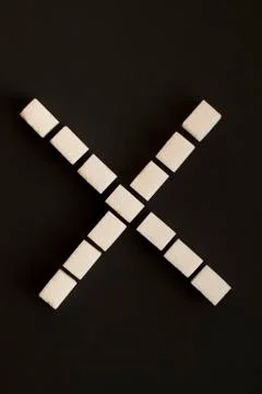 Sugar cubes in a shape of x Stock Photos